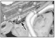 17.6 Hose bracket bolted to cylinder head (arrowed)