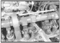 23.7a Using a feeler gauge to check a valve clearance