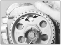 18.6b TDC pointer on camshaft sprocket aligned with dot on cylinder head -