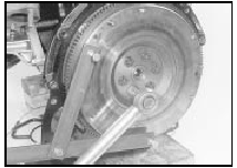 24.2 Using an improvised tool to hold the flywheel stationary while