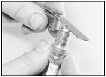 11.9a Measuring a spark plug gap using a feeler blade