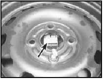 7.3b Fuel pump inertia cut-off switch location (arrowed) under spare wheel