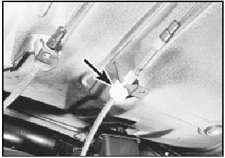 28.3 Handbrake cable adjuster on left-hand underbody bracket (arrowed)