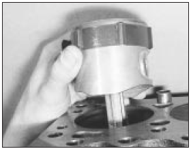 8.12 Fitting a piston/connecting rod assembly with ring compressor in