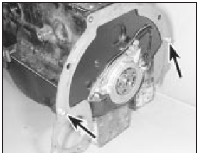 15.18a Locate the engine adapter plate over the dowels (arrowed) . . .