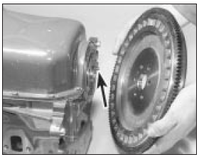 15.43b Fitting the flywheel to the crankshaft (dowel arrowed) - HCS engine
