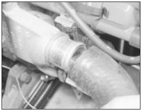 7.4 Disconnecting the hose from the thermostat housing - carburettor engine